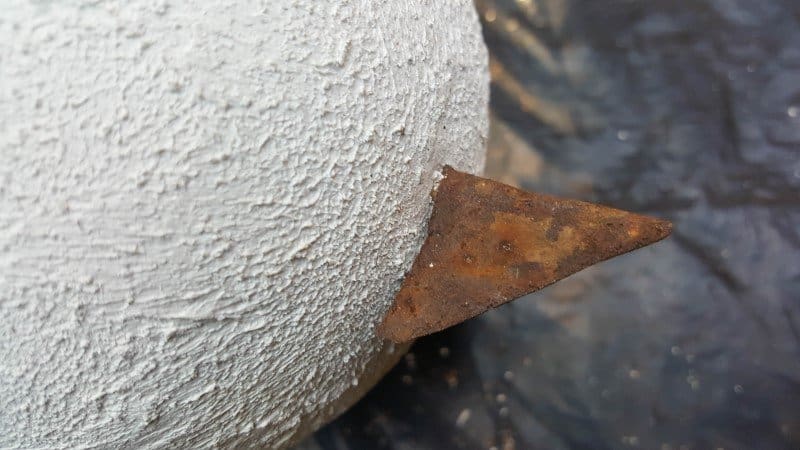 Glue the rusty metal beak onto the skewer and trim away any excess