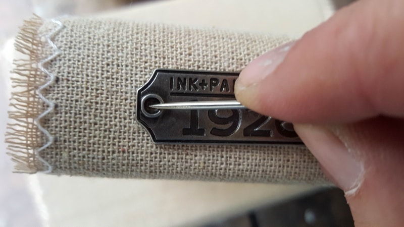 Mark where to sew the tag and remove the covers before sewing