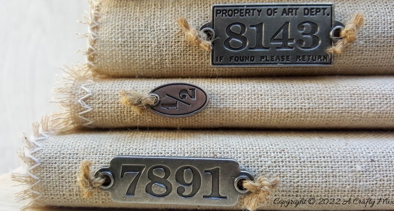 Do you like making a stylish statement while indulging your reading obsession? Then you&rsquo;re going to love these easy to make linen book covers with metal tags. Not only can you dress up your old or new books up in new attire, but you can customise the tutorial to suit your d&eacute;cor style. #DIYBookCovers #ACraftyMix #StylishBooks