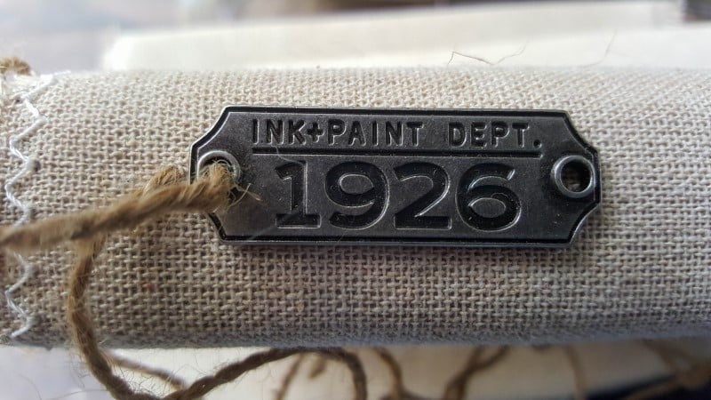 Use twine or thread to sew the metal tags onto the book covers