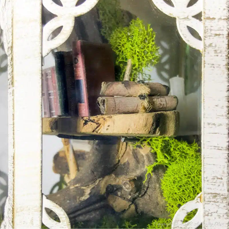 One of the reasons I love miniatures so much is how they draw the viewer in and encourage deeper scrutiny. Like this DIY pixie den lantern. It’s filled with ancient scrolls, fairy-tale artifacts and a light that casts a magical glow over everything. Make your own with this photo-rich tutorial #FairyGarden #ACraftyMix #CraftTutorial