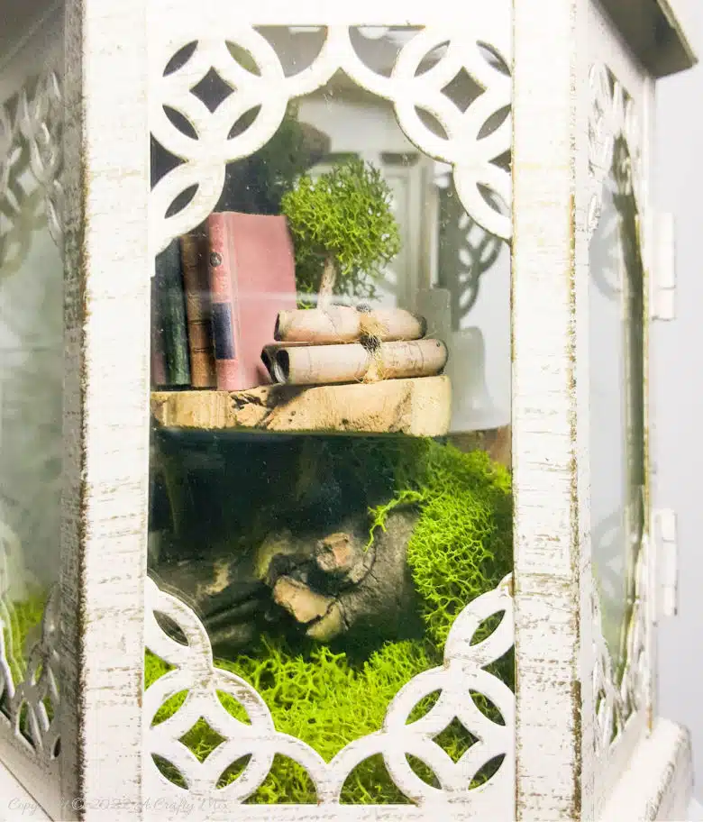 One of the reasons I love miniatures so much is how they draw the viewer in and encourage deeper scrutiny. Like this DIY pixie den lantern. It’s filled with ancient scrolls, fairy-tale artifacts and a light that casts a magical glow over everything. Make your own with this photo-rich tutorial #FairyGarden #ACraftyMix #CraftTutorial