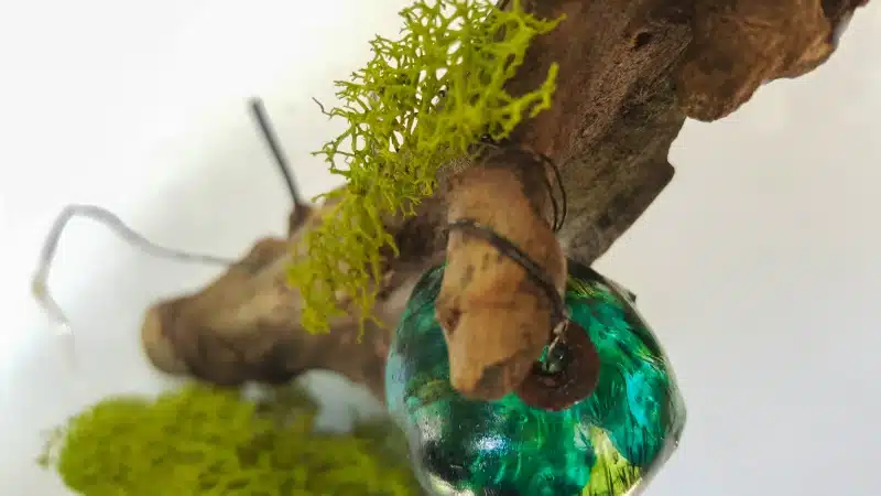 Use small bits of moss to hide the wiring