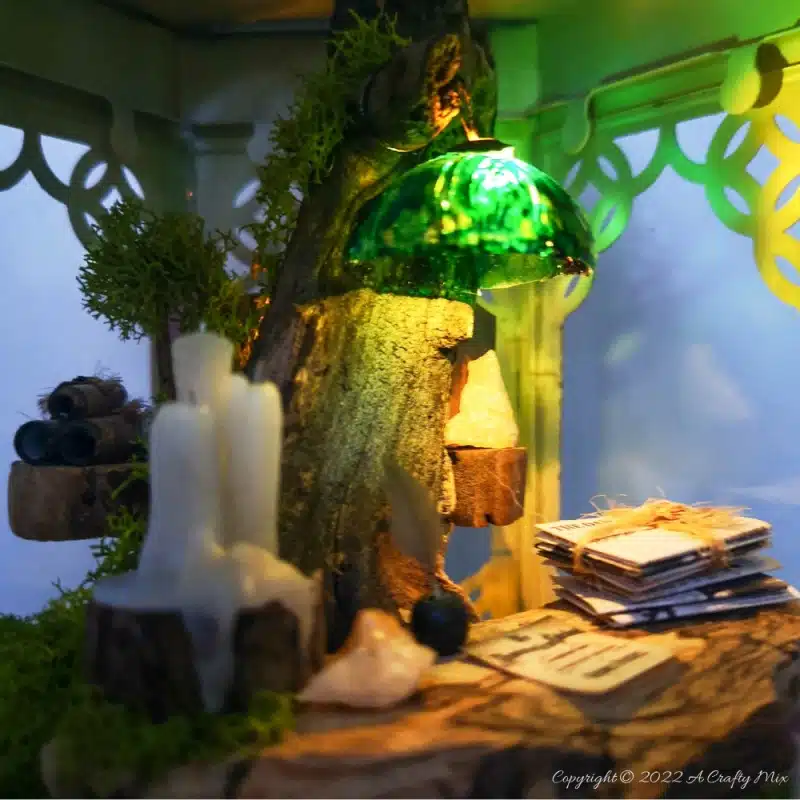 One of the reasons I love miniatures so much is how they draw the viewer in and encourage deeper scrutiny. Like this DIY pixie den lantern. It’s filled with ancient scrolls, fairy-tale artifacts and a light that casts a magical glow over everything. Make your own with this photo-rich tutorial #FairyGarden #ACraftyMix #CraftTutorial