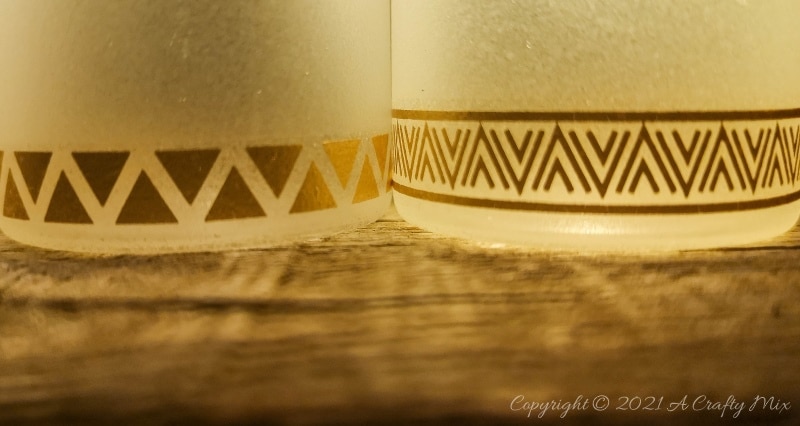 A perfect beginner-friendly home decor project that only takes a few minutes to make! These gorgeous glass bottle lights with gold accents look lovely no matter where you display them. Place them on your mantle or bookshelf or use them as a centerpiece at a special event or bridal shower. #DIYBottleDecor #ACraftyMix #GlassBottleIdeas