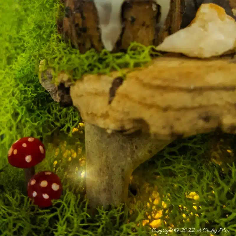One of the reasons I love miniatures so much is how they draw the viewer in and encourage deeper scrutiny. Like this DIY pixie den lantern. It’s filled with ancient scrolls, fairy-tale artifacts and a light that casts a magical glow over everything. Make your own with this photo-rich tutorial #FairyGarden #ACraftyMix #CraftTutorial