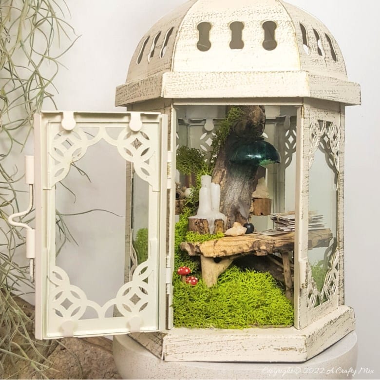 One of the reasons I love miniatures so much is how they draw the viewer in and encourage deeper scrutiny. Like this DIY pixie den lantern. It’s filled with ancient scrolls, fairy-tale artifacts and a light that casts a magical glow over everything. Make your own with this photo-rich tutorial #FairyGarden #ACraftyMix #CraftTutorial
