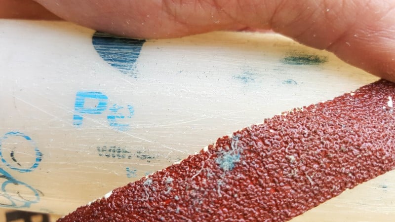 Sand the plastic bottle to provide grip for the glue step
