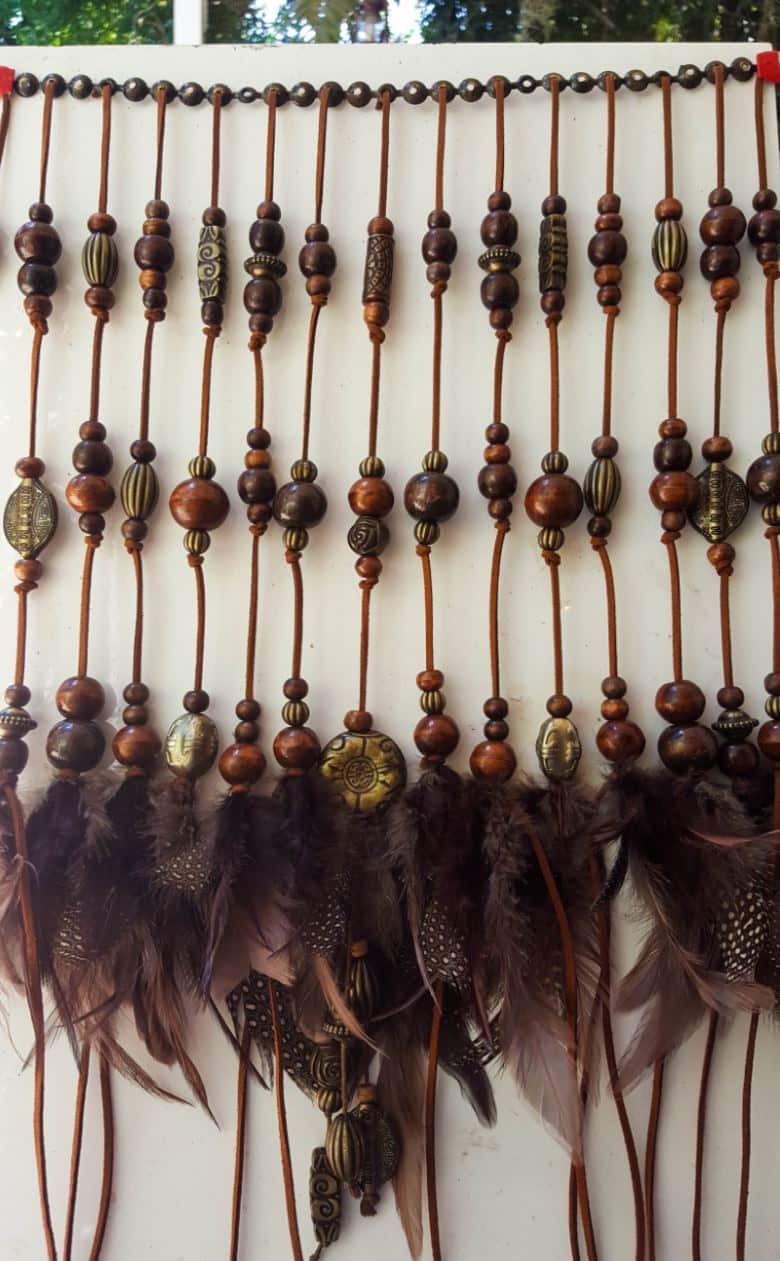 Add the feathers and beads to the leather cords