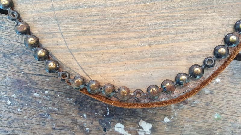 Bend the nail strip around the bottom of the board