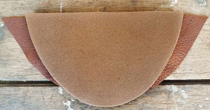 Cut a piece of leather that's wider at the top than the board