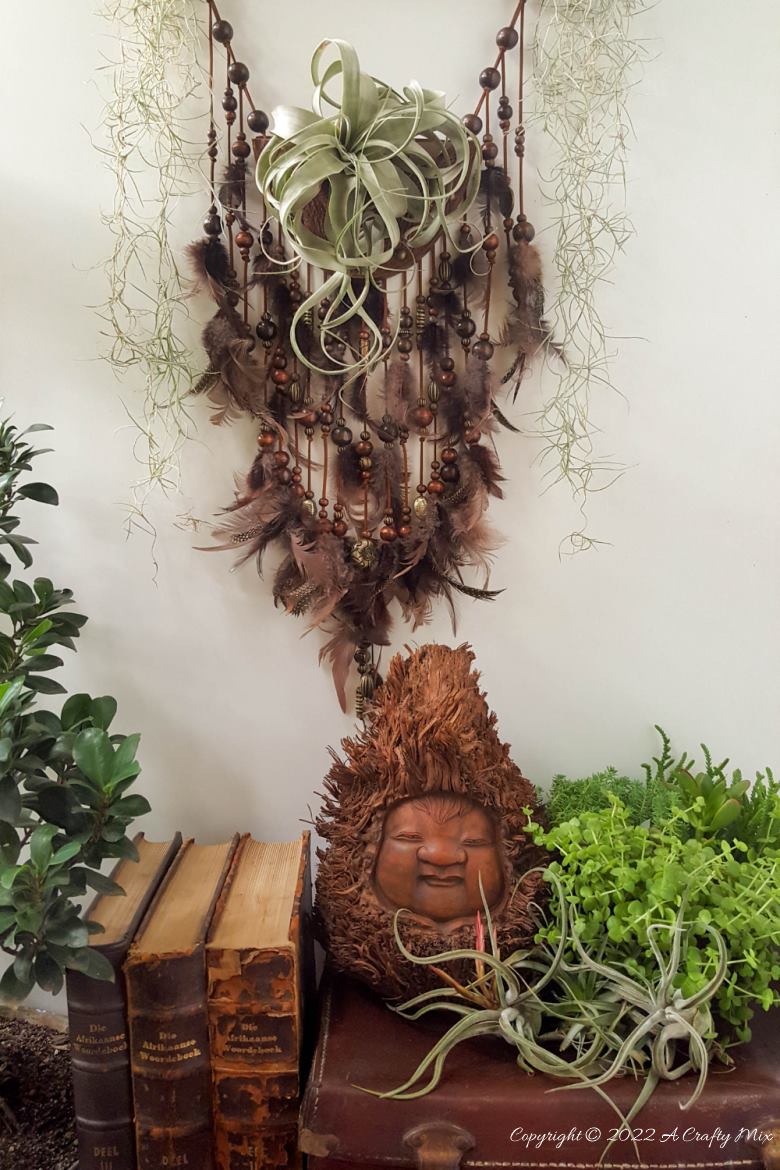 Do you enjoy making planters that serve a dual purpose? We sure do. I've been nurturing a rather large air plant for a while and wanted to make something that would put her center stage and add a little boho magic to our decor. And I think I may have done just that with this leather Tillandsia planter. Get the full tutorial here. #diyairplanter #AcraftyMix #livingwalldecor