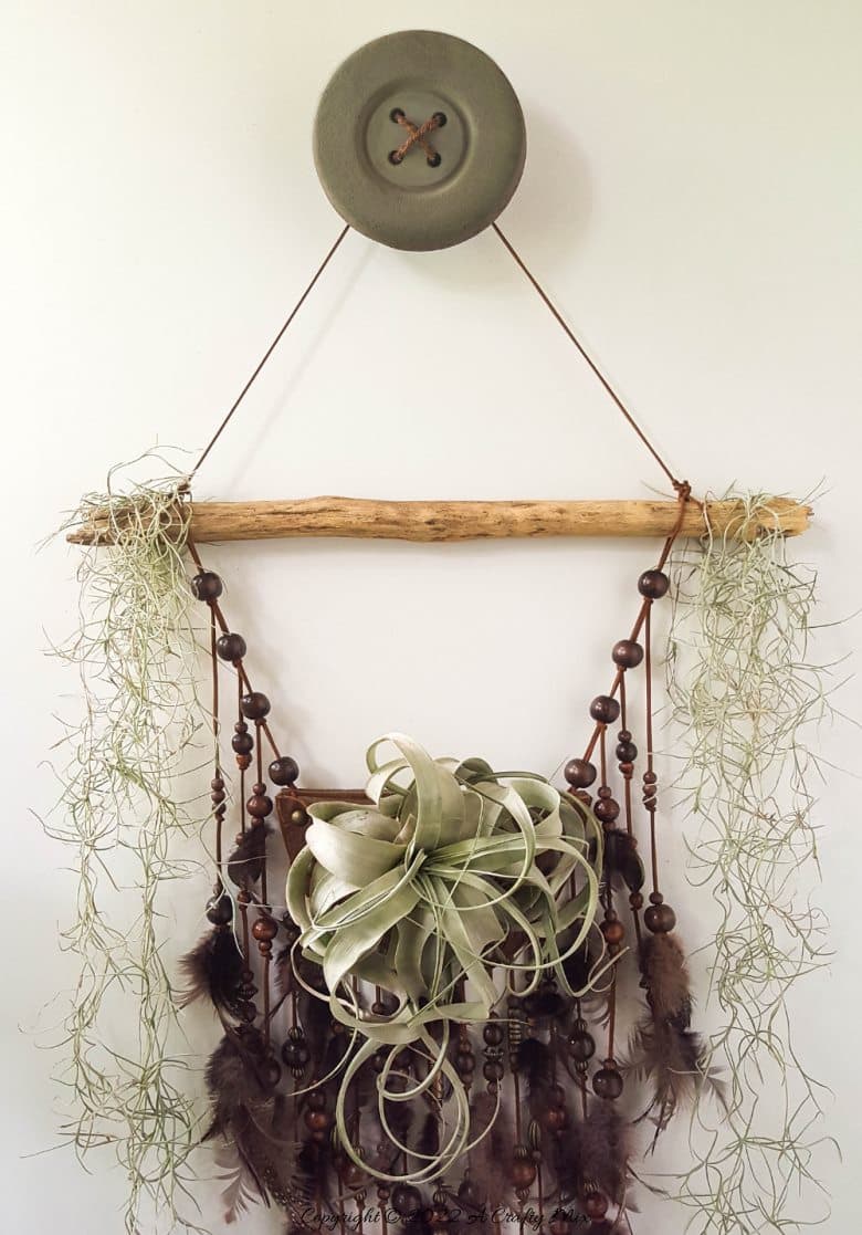 Do you enjoy making planters that serve a dual purpose? We sure do. I've been nurturing a rather large air plant for a while and wanted to make something that would put her center stage and add a little boho magic to our decor. And I think I may have done just that with this leather Tillandsia planter. Get the full tutorial here. #diyairplanter #AcraftyMix #livingwalldecor