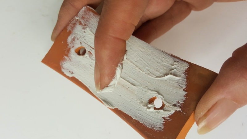 Apply some gesso or paint to seal the terra cotta