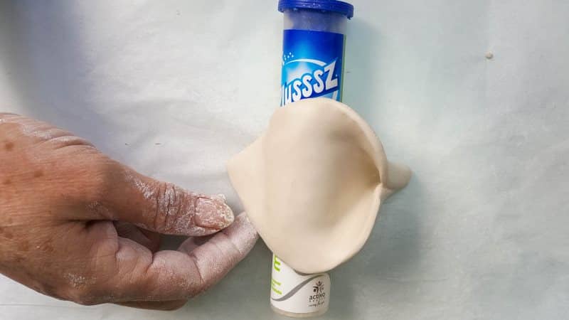 Place the arum lily over a tube form to dry