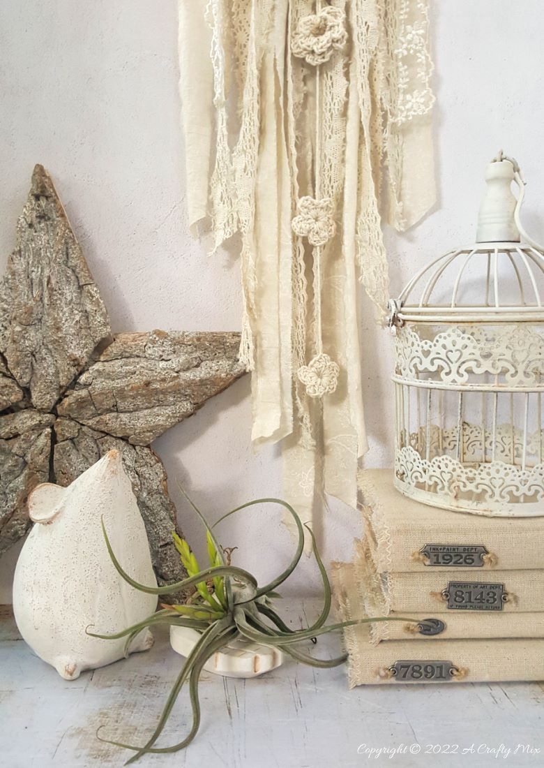 Looking for a charming way to incorporate plants in your d&eacute;cor? This repurposed doily air plant holder is quick and easy to make and can be hung anywhere to add a little natural greenery to your home. #ACraftyMix #BrokenTerraCotta #GreenWallDecor