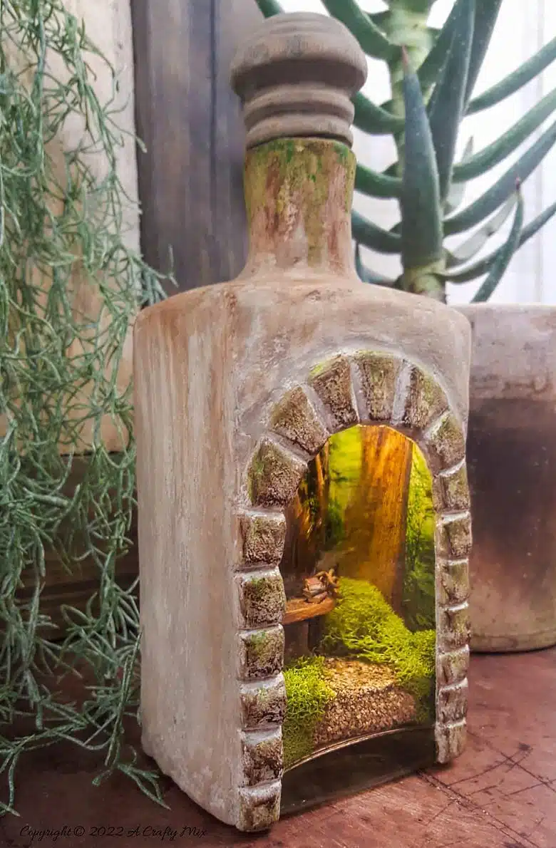 Welcome, fairy lovers! I had so much fun creating this feathered fairy throne in a fantasy bottle after seeing altered bottles in my Pinterest feed. It lights up and once I had everything figured out, it was really easy to make too. #ACraftyMix #AlteredBottle