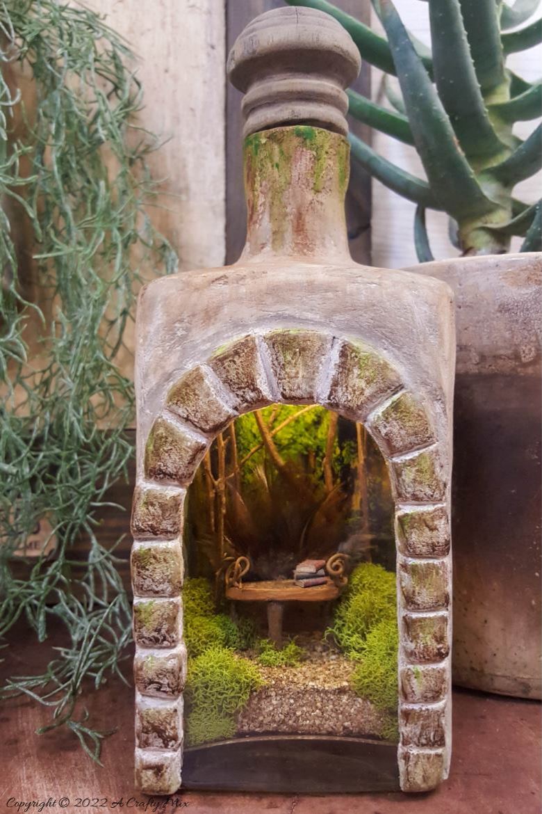 Welcome, fairy lovers! I had so much fun creating this feathered fairy throne in a fantasy bottle after seeing altered bottles in my Pinterest feed. It lights up and once I had everything figured out, it was really easy to make too. #ACraftyMix #AlteredBottle