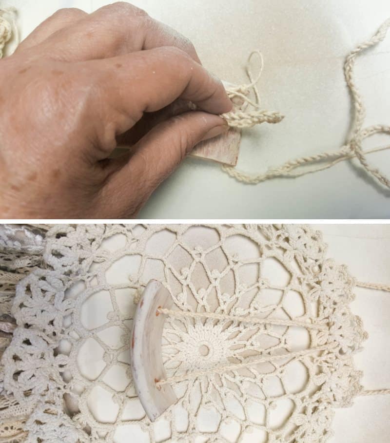 Make a knot in the crochet chain and thread it through the terra cotta shard and tie it onto the doily hoop