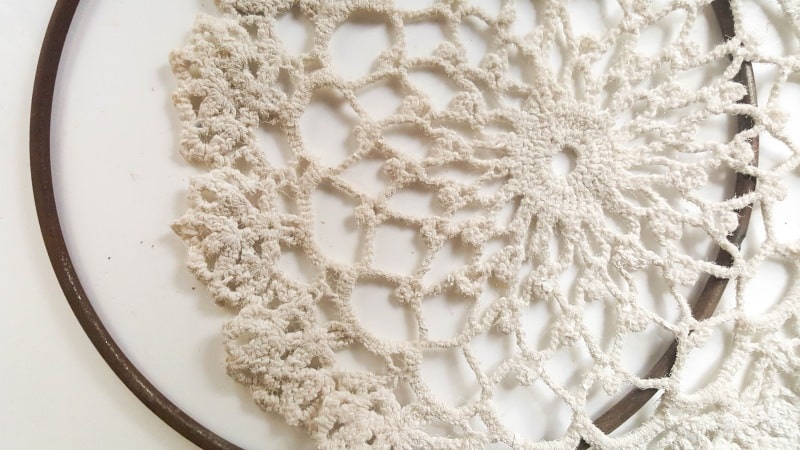Paint the hoop so it tones in with the doily