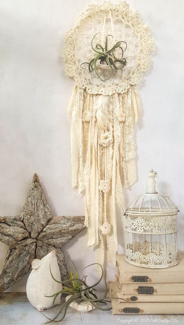 Looking for a charming way to incorporate plants in your d&eacute;cor? This repurposed doily air plant holder is quick and easy to make and can be hung anywhere to add a little natural greenery to your home. #ACraftyMix #BrokenTerraCotta #GreenWallDecor
