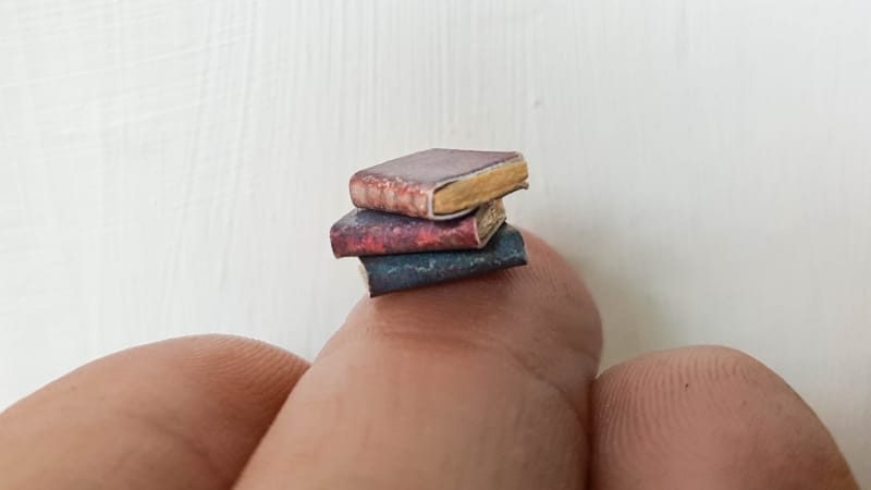 A collection of teeny, tiny books that will go inside the altered bottle
