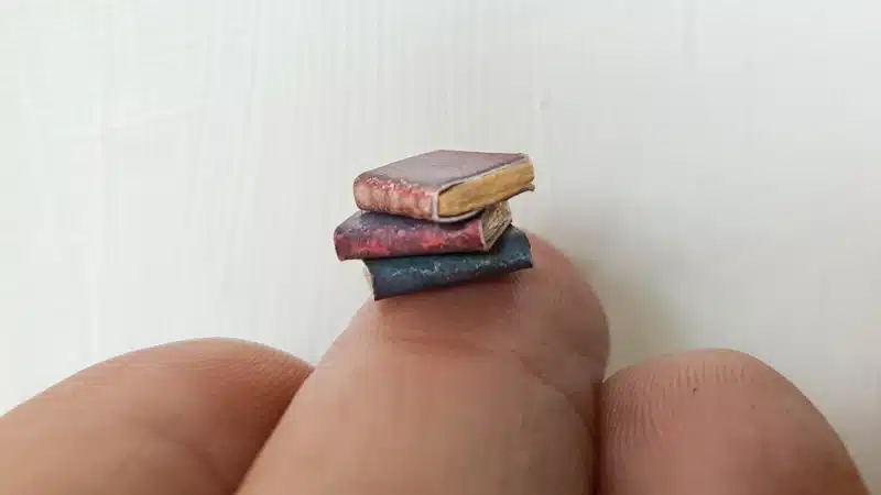 A collection of teeny, tiny books that will go inside the altered bottle
