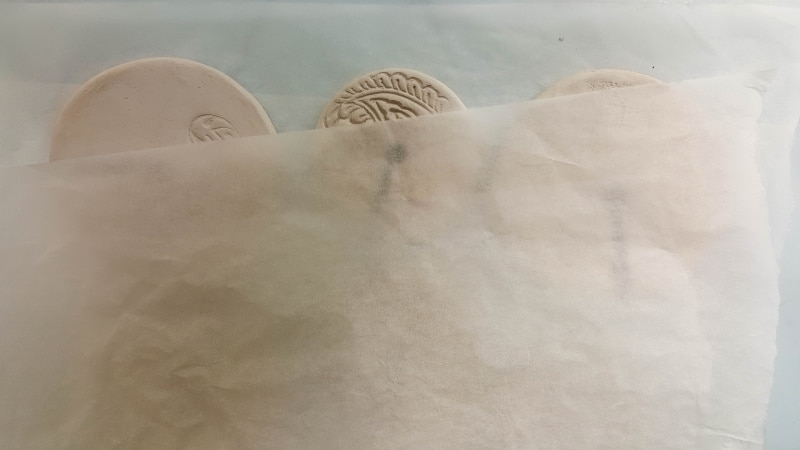 Place some wax paper over the clay discs and leave to dry