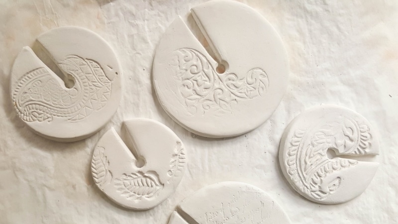 Once the air-dry clay dries, seal the discs with two coats of clear matte varnish