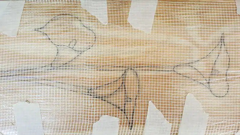 Use tape to secure the mesh to the board