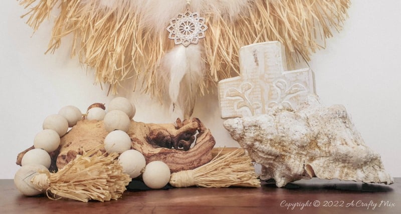 Handmade Raffia Collar Necklace Home D&eacute;cor or Wall Hanging using cardboard and beads. Quick, easy, budget-friendly, and fun to put together, it will add a touch of tribal boho to any space. Get the free step-by-step tutorial at A Crafty Mix. #BohoDecorDIY #ACraftyMix