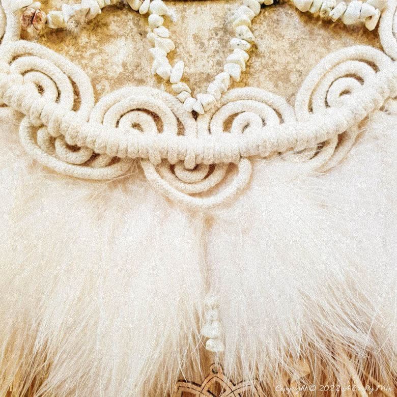 Handmade Raffia Collar Necklace Home D&eacute;cor or Wall Hanging using cardboard and beads. Quick, easy, budget-friendly, and fun to put together, it will add a touch of tribal boho to any space. Get the free step-by-step tutorial at A Crafty Mix. #BohoDecorDIY #ACraftyMix
