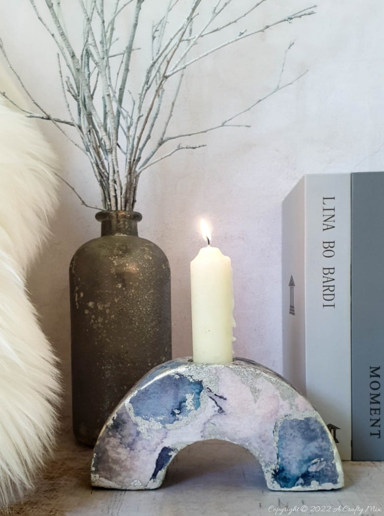 No matter your décor style, this easy to make concrete arch candle holder will light up the dinner table and look stunning on a window sill or bookshelf! No special tools or molds required and you can customize them to suit your unique look and vibe. #ACraftyMix