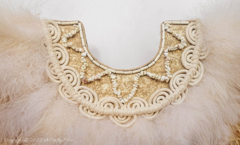 Handmade Raffia Collar Necklace Home D&eacute;cor or Wall Hanging using cardboard and beads. Quick, easy, budget-friendly, and fun to put together, it will add a touch of tribal boho to any space. Get the free step-by-step tutorial at A Crafty Mix. #BohoDecorDIY #ACraftyMix