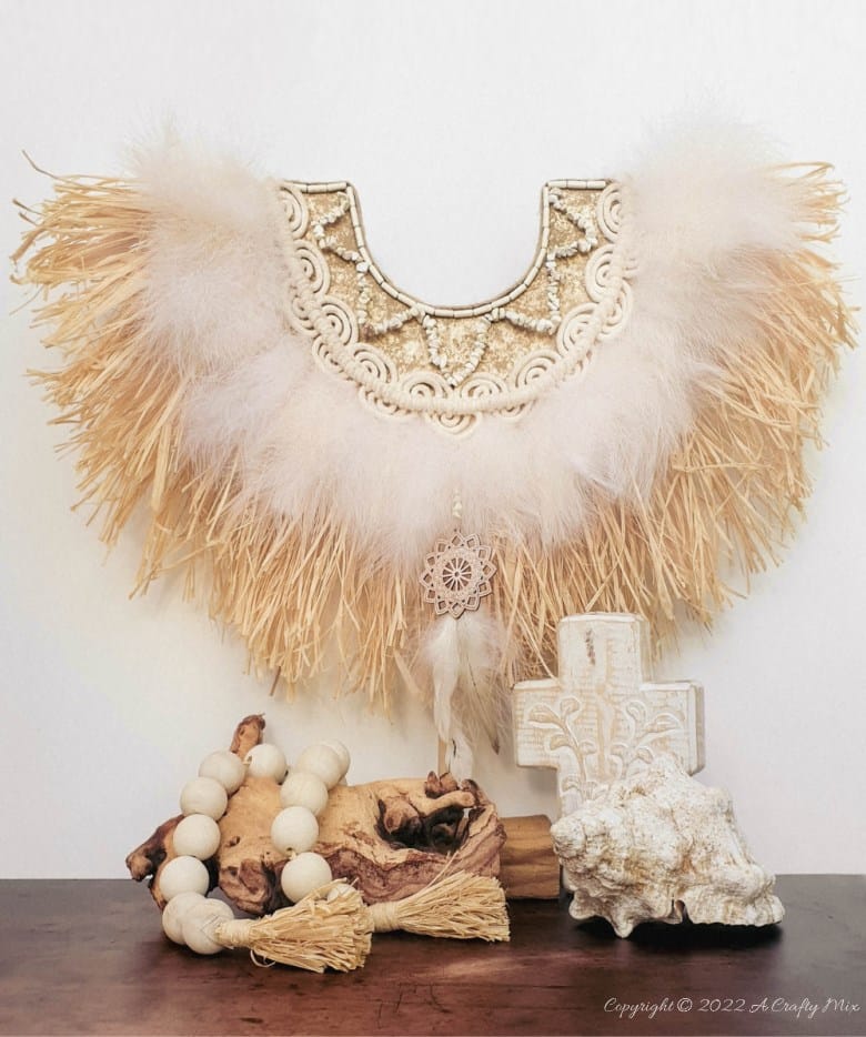 Handmade Raffia Collar Necklace Home D&eacute;cor or Wall Hanging using cardboard and beads. Quick, easy, budget-friendly, and fun to put together, it will add a touch of tribal boho to any space. Get the free step-by-step tutorial at A Crafty Mix. #BohoDecorDIY #ACraftyMix