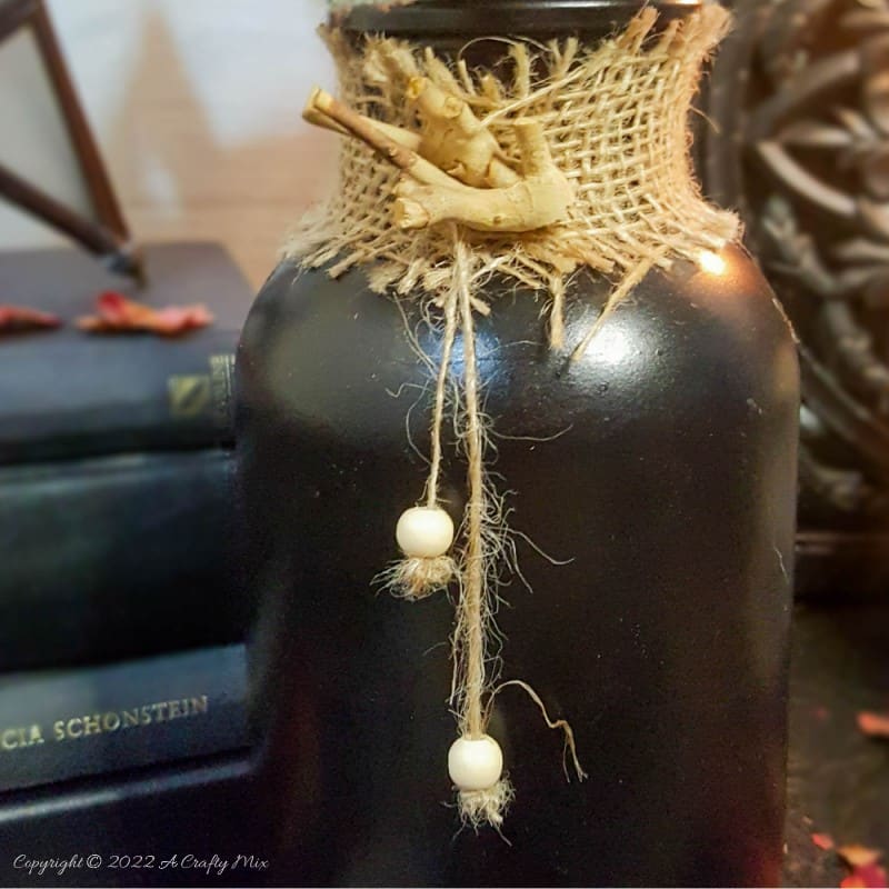 Add a not-so-creepy touch to your All Hallows' Eve Gathering with these easy-to-make Halloween place card holders. They only take a few minutes to put together and will make both your wallet and your dinner guests smile. #ACraftyMix #HalloweenDecor