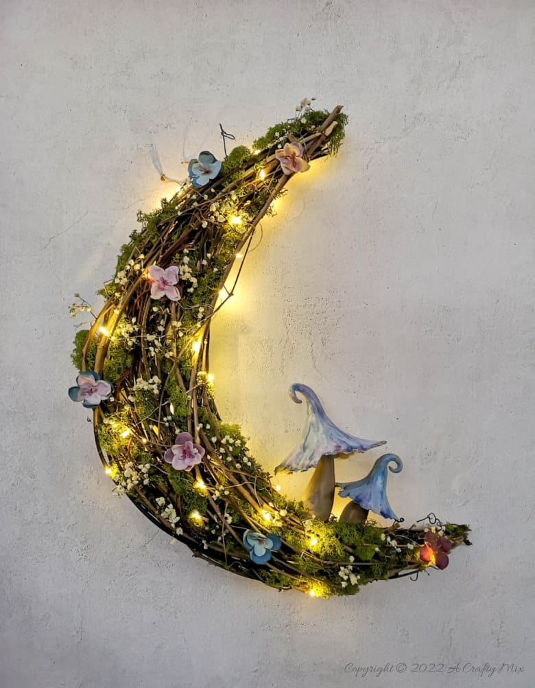 This how-to guide will show you how to make a gorgeous crescent moon wreath from scratch. It includes a step-by-step video tutorial to make fantasy-inspired curly top mushrooms. #ACraftyMix #FantasyWreath