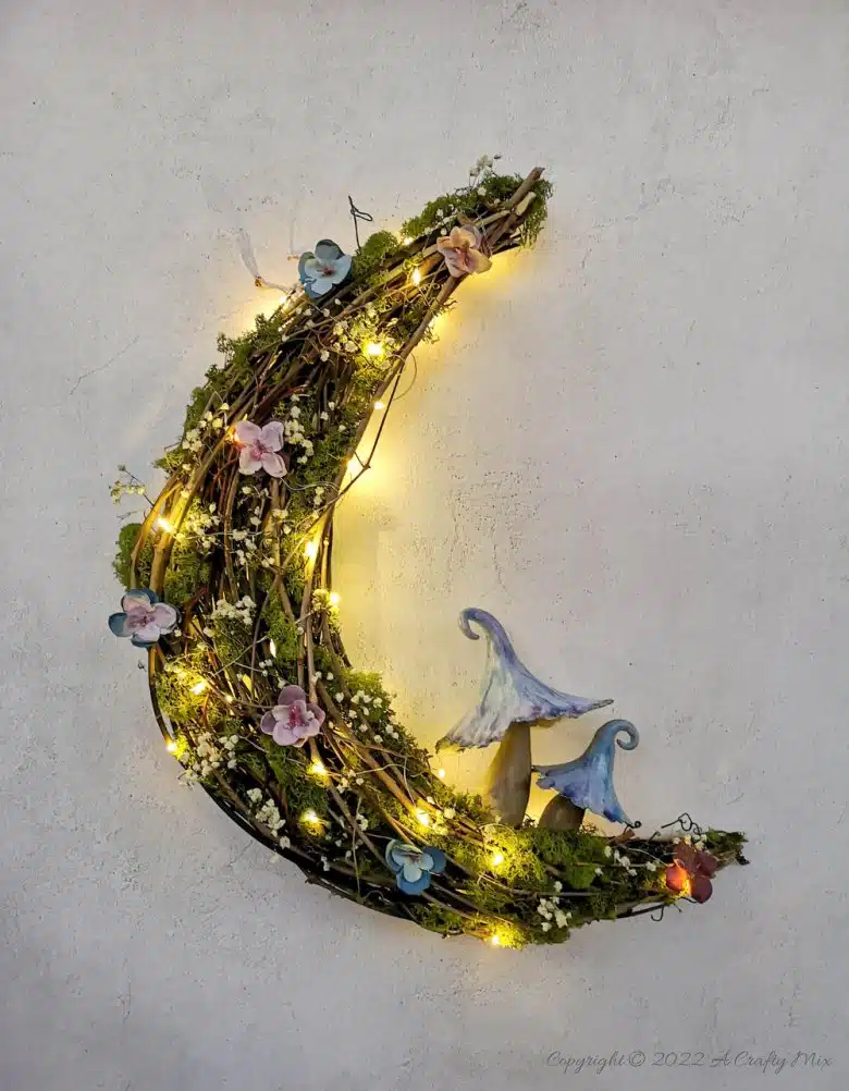 This how-to guide will show you how to make a gorgeous crescent moon wreath from scratch. It includes a step-by-step video tutorial to make fantasy-inspired curly top mushrooms. #ACraftyMix #FantasyWreath