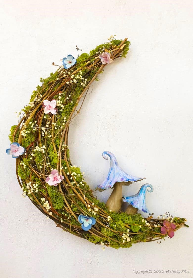 This how-to guide will show you how to make a gorgeous crescent moon wreath from scratch. It includes a step-by-step video tutorial to make fantasy-inspired curly top mushrooms. #ACraftyMix #FantasyWreath