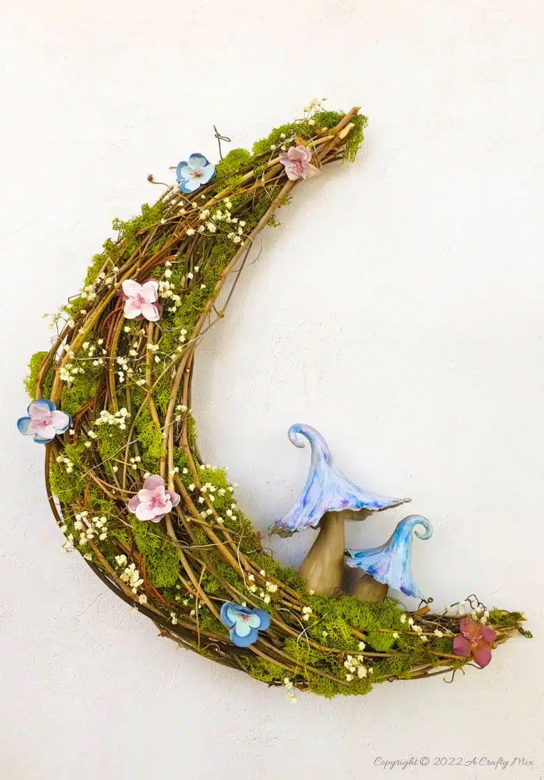 This how-to guide will show you how to make a gorgeous crescent moon wreath from scratch. It includes a step-by-step video tutorial to make fantasy-inspired curly top mushrooms. #ACraftyMix #FantasyWreath