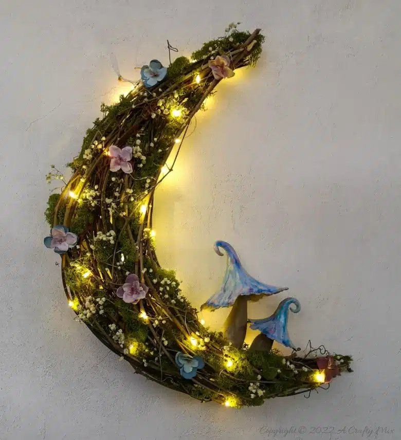 This how-to guide will show you how to make a gorgeous crescent moon wreath from scratch. It includes a step-by-step video tutorial to make fantasy-inspired curly top mushrooms. #ACraftyMix #FantasyWreath