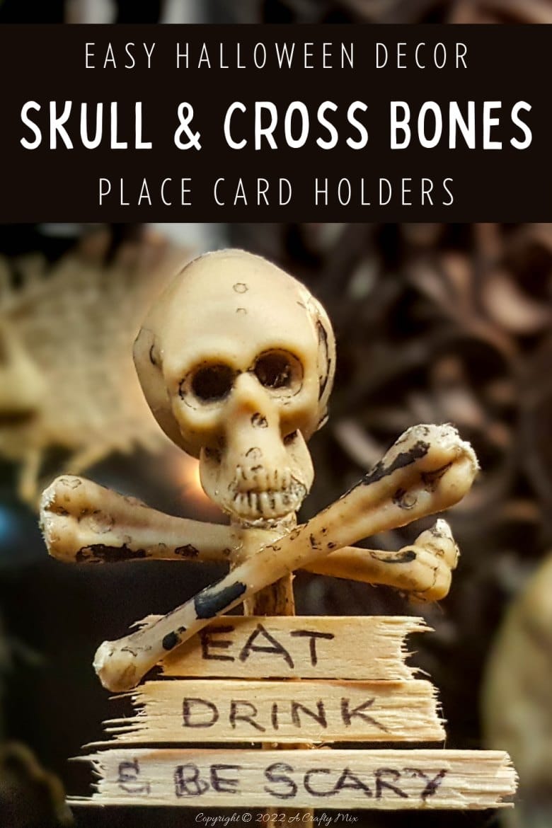 Add a not-so-creepy touch to your All Hallows' Eve Gathering with these easy-to-make skull and crossbones place card holders. They only take a few minutes to put together and will make both your wallet and your dinner guests smile. #ACraftyMix #HalloweenDecor