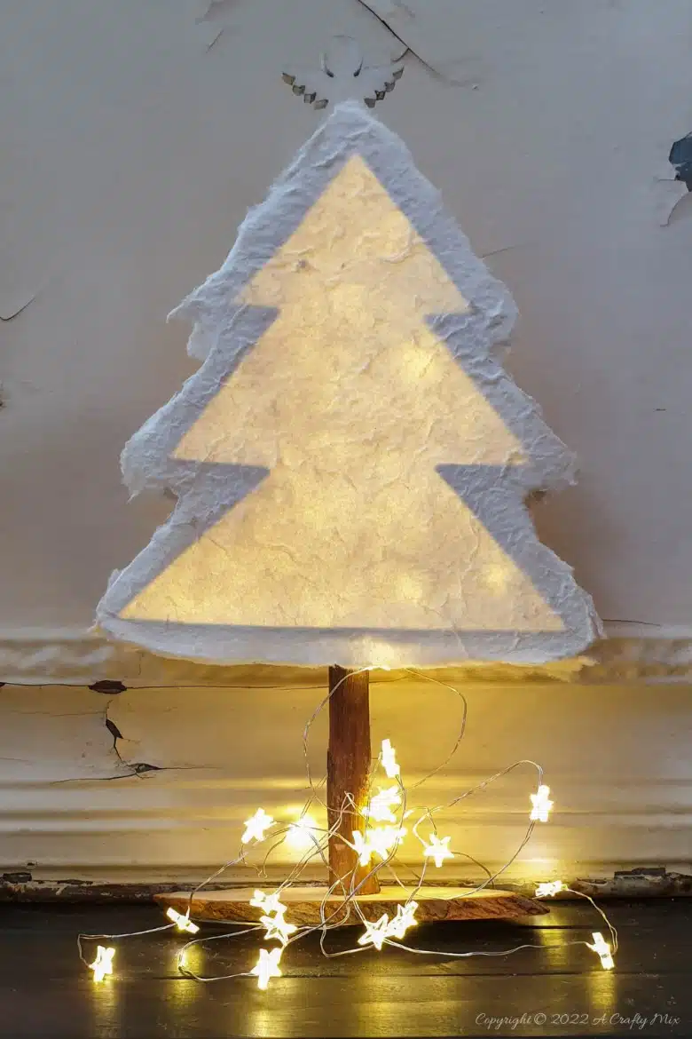 Do you want to make something that's both gorgeous and budget-friendly this festive season? If so, these easy-to-make, handmade paper Christmas trees tick all the right boxes. They look great on the mantle or a table and the lights give them a beautiful warm glow. #ACraftyMix #Tutorial