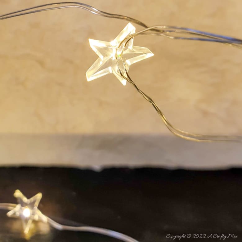 Do you want to make something that's both gorgeous and budget-friendly this festive season? If so, these easy-to-make, handmade paper Christmas trees tick all the right boxes. They look great on the mantle or a table and the lights give them a beautiful warm glow. #ACraftyMix #Tutorial