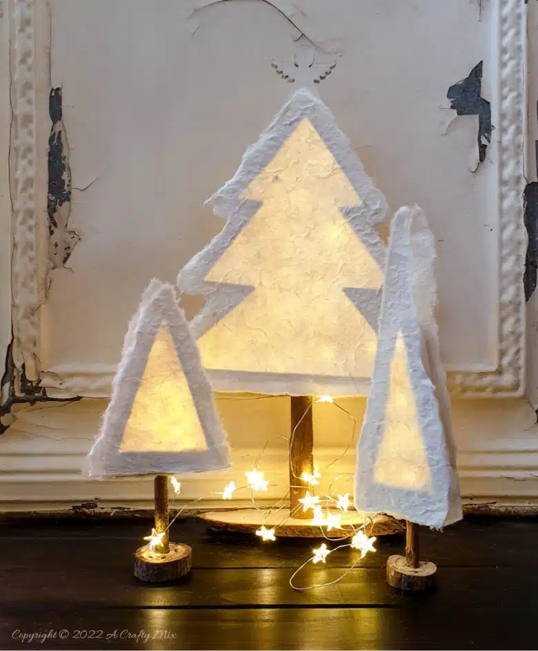 Do you want to make something that's both gorgeous and budget-friendly this festive season? If so, these easy-to-make, handmade paper Christmas trees tick all the right boxes. They look great on the mantle or a table and the lights give them a beautiful warm glow. #ACraftyMix #Tutorial