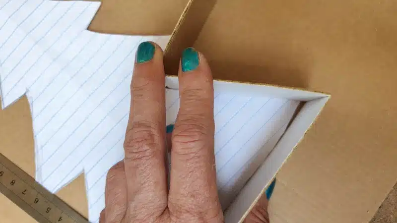 Use the paper cut-out tree as a guide to bend and shape the cardboard strips