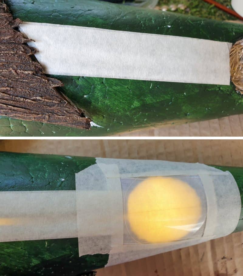 Tape the clear plastic window down and cover the slit in the polystyrene cone