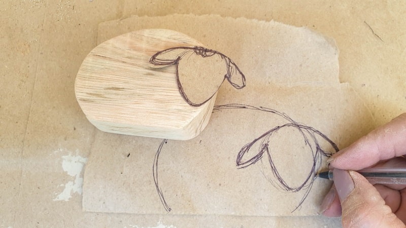 Sketch a sheep head shape and test fit on the body