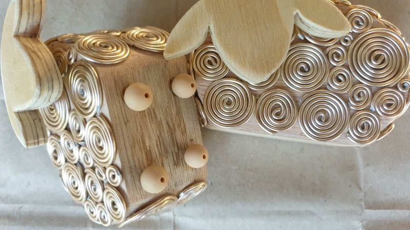 Glue four small beads to the bottom of the sheep