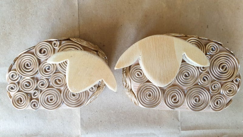Glue the wire spirals onto the sheep's body